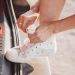 person wearing white low top sneakers