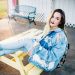 smiling woman sitting on yellow picnic table during daytime