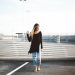 woman standing on gray concrete pavement