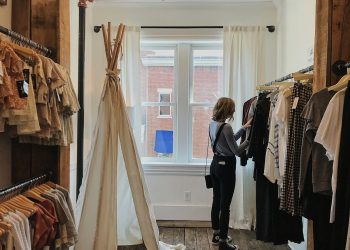 woman standing selecting clothes